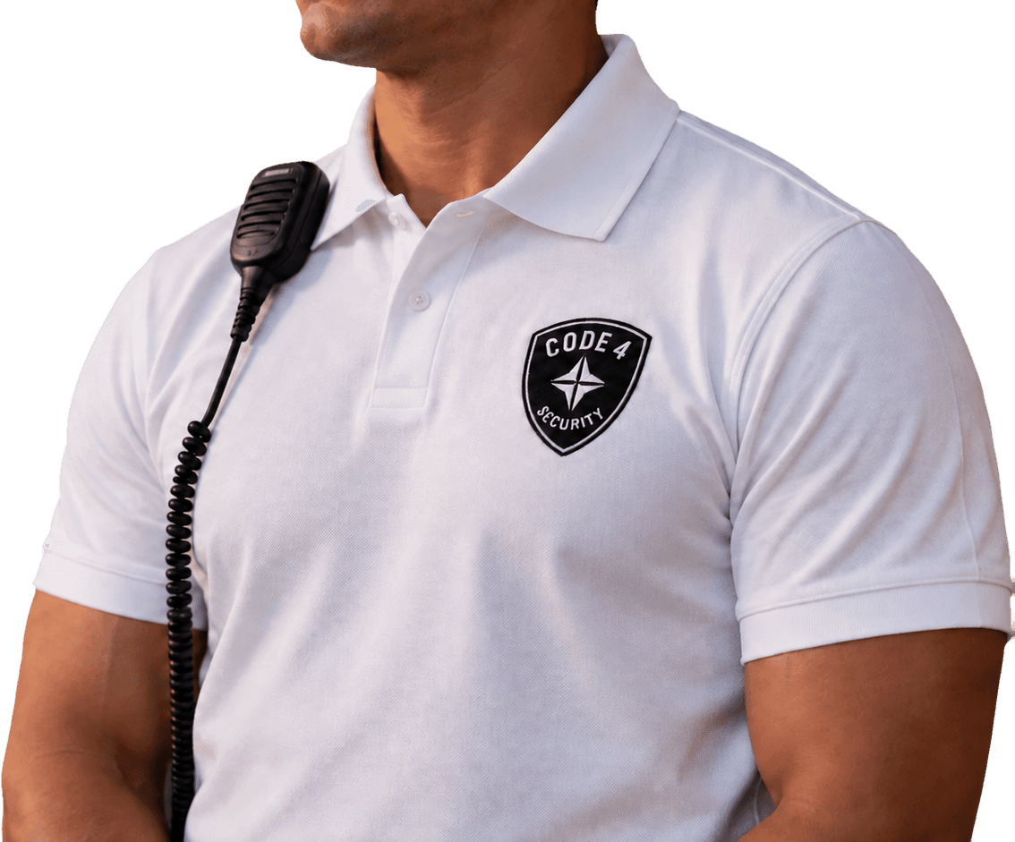 Code 4 security professional in a branded white polo with a radio microphone